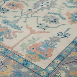 Elegant Pastel Tribal Floral Hand Knotted Wool Rug with Soft Blue Border